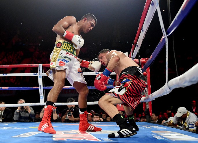 Roman Gonzalez punches McWilliams Arroyo on way to a unanimous 12 round decision during a WBC flyweight title fight at The Forum on April 23, 2016 in Inglewood, California.