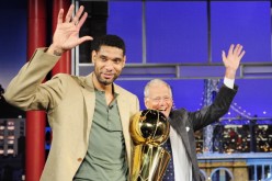 Tim Duncan clutches the Larry O'Brien championship trophy while guesting in the Late Show With David Letterman.