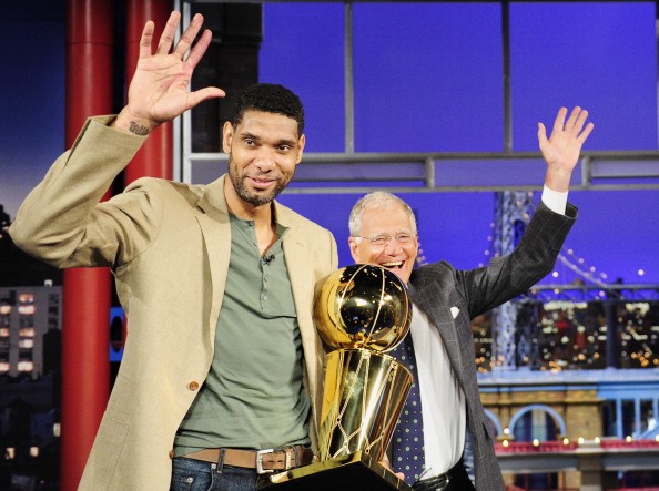 Tim Duncan clutches the Larry O'Brien championship trophy while guesting in the Late Show With David Letterman.