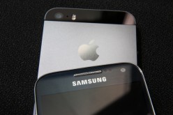 A Samsung and Apple smartphone are displayed on August 6, 2014 in London, England. 