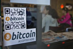 An establishment displays a sign showing that Bitcoin is accepted as payment.
