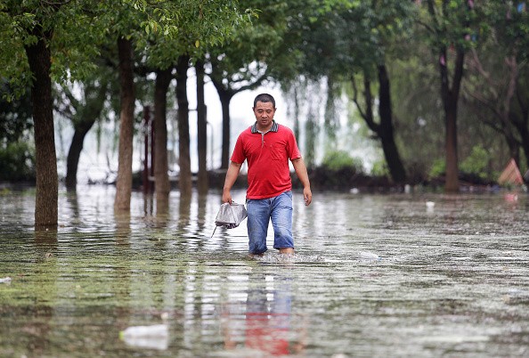 A villager walking in the flood of Niushan Lake on July 14, 2016 in Wuhan, Hubei Province, China.
