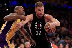 Los Angeles Clippers power forward Blake Griffin (R) drives past Los Angeles Lakers' Metta World Peace.