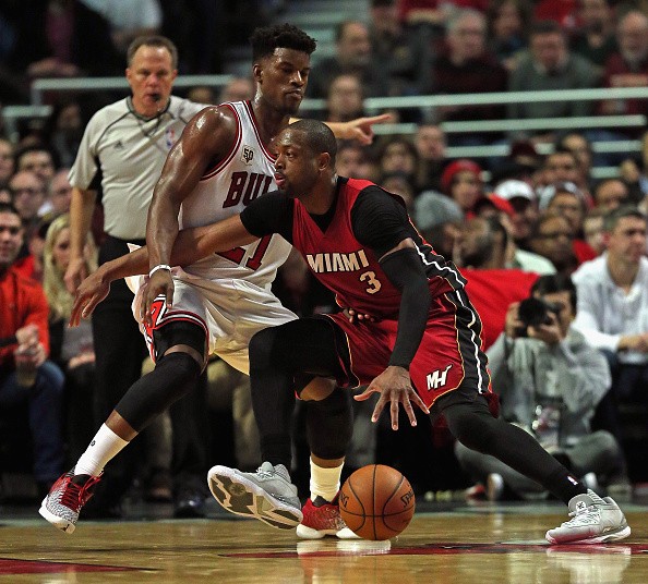 Dwyane Wade is defended by the Bulls' Jimmy Butler in a Heat-Bulls game in Chicago.