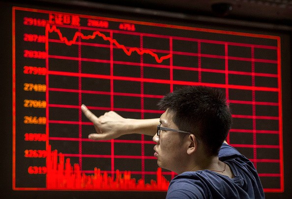 A Chinese day trader reacts as he watches a stock ticker at a local brokerage house on August 27, 2015 in Beijing, China.