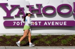 A woman jogs past Yahoo's logo at its headquarters in Sunnyvale, California.