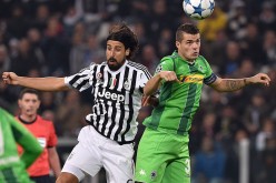 Former Borussia Monchengladbach midfielder Granit Xhaka (R) competes for the ball against Juventus' Sami Khedira.