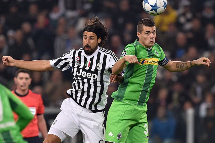 Former Borussia Monchengladbach midfielder Granit Xhaka (R) competes for the ball against Juventus' Sami Khedira.