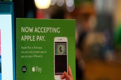 Apple Pay is promoted on signs placed at the cash register of Whole Foods in Columbus Circle on October 20, 2014 in New York, NY. The software, which debuted today, is available in the recently updated iPhone 6 software and accepted in 220,000 stores. It 