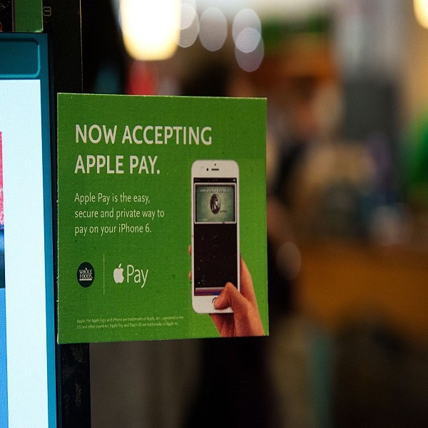 Apple Pay is promoted on signs placed at the cash register of Whole Foods in Columbus Circle on October 20, 2014 in New York, NY. The software, which debuted today, is available in the recently updated iPhone 6 software and accepted in 220,000 stores. It 