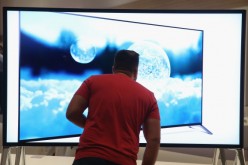 A visitor looks at a 4000K television at the Sony stand at the 2014 IFA home electronics and appliances trade fair.