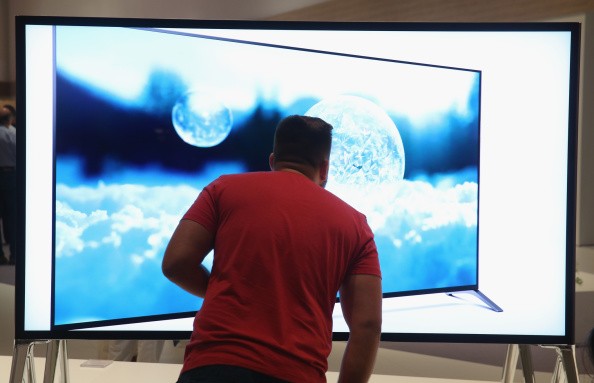 A visitor looks at a 4000K television at the Sony stand at the 2014 IFA home electronics and appliances trade fair.
