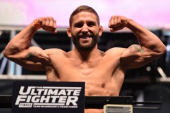 Chad Mendes flexes his biceps during a UFC weigh-in last December 2015