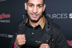 Amir Khan has sent mixed signals after posing with the UFC title inside the Octagon and shared on Instagram