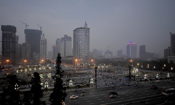 The tall buildings of Chengdu financial district are seen in the background of the photo of the downtown area. 