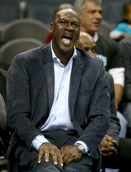 Charlotte Hornets owner reacts to a referee's call during a Hornets home game.