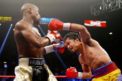 Manny Pacquiao throws a left at Floyd Mayweather Jr. during their welterweight unification championship bout on May 2, 2015 at MGM Grand Garden Arena in Las Vegas, Nevada.