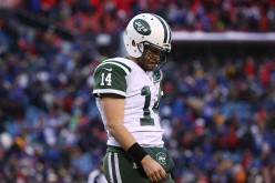 Ryan Fitzpatrick #14 of the New York Jets walks off the field after throwing his third interception of the day in a 22-17 loss to the Buffalo Bills at Ralph Wilson Stadium on January 3, 2016 in Orchard Park, New York.