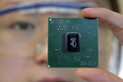 An Intel employee shows a chipset made in the company's plant in Chengdu.