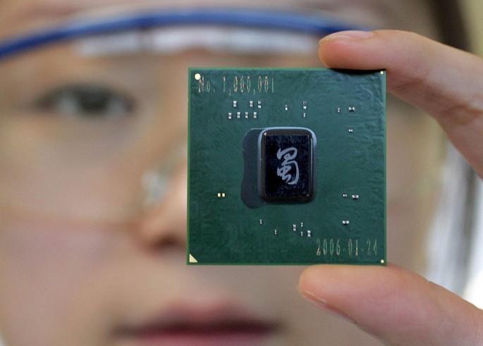 An Intel employee shows a chipset made in the company's plant in Chengdu.