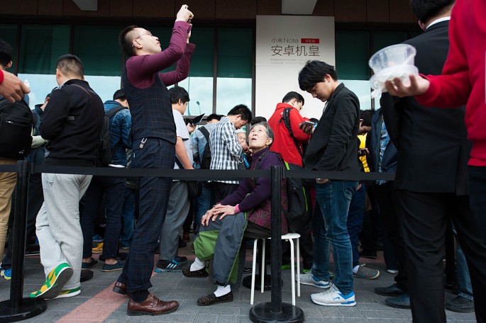Customers wait in line at a Xiaomi experience store on May 12, 2015, in Beijing, China.
