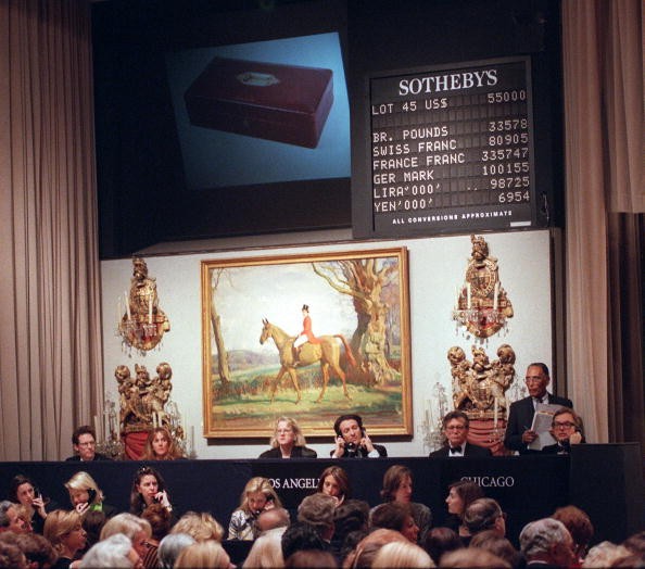Employees at Sotheby's take calls from bidders during an auction.