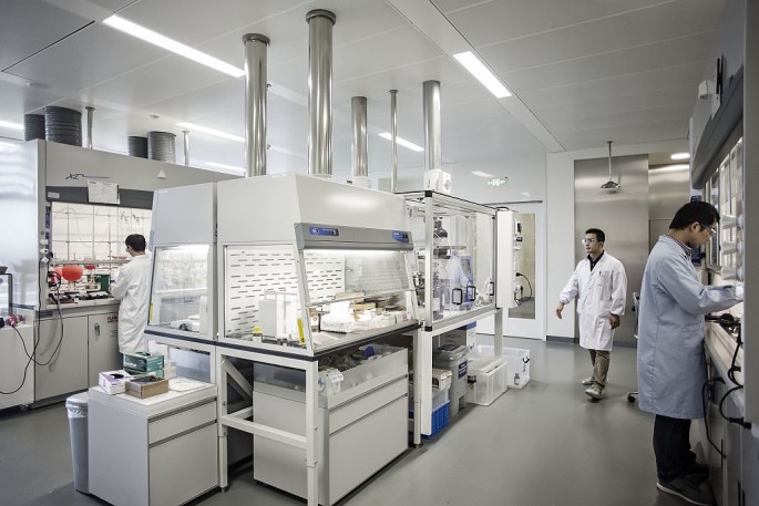 Researchers work in a medical lab of Novartis in Shanghai.