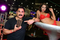 Television personality Reza Farahan and a model display his Phantom Smoke hookah products at the 29th annual Nightclub & Bar Convention and Trade Show at the Las Vegas Convention Center on March 25, 2014 in Las Vegas, Nevada.