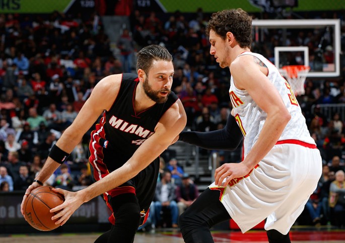 Miami Heat power forward Josh McRoberts goes against Atlanta Hawks' Mike Muscala.