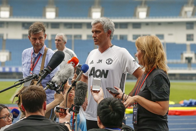 Manchester United manager Jose Mourinho (middle) talks to reporters during the team's recent China visit.