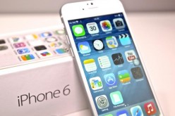 The iPhone 6 is freshly opened and leaning toward its box, which is the latest generation from Apple before iPhone 7's release this September.
