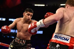 Amir Khan (L) and Canelo Alvarez battle during a WBC middleweight title fight at T-Mobile Arena on May 7, 2016 in Las Vegas, Nevada.
