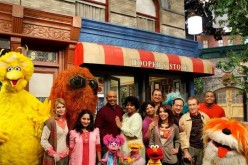 The complete casts of “Sesame Street” pose for the camera.