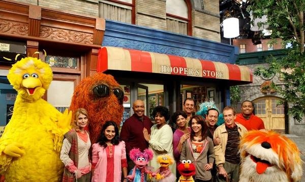 The complete casts of “Sesame Street” pose for the camera.