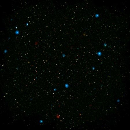 The blue dots in this field of galaxies, known as the COSMOS field, show galaxies that contain supermassive black holes emitting high-energy X-rays. They were detected by NASA's Nuclear Spectroscopic Array, or NuSTAR, which spotted 32 such black holes in 