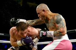Miguel Cotto throws a right at Canelo Alvarez during their middleweight fight at the Mandalay Bay Events Center on November 21, 2015 in Las Vegas, Nevada.