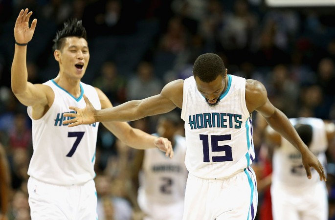 Teammates Jeremy Lin #7 and Kemba Walker #15 of the Charlotte Hornets react after a play during their game against the Chicago Bulls at Time Warner Cable Arena on October 19, 2015 in Charlotte, North Carolina.