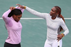 Venus Williams and Serena Williams of the United States talk during a break from a practice session ahead of the 2016 Summer Olympic Games at the Olympic Tennis Centre on August 3, 2016 in Rio de Janeiro, Brazil.