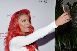 Eva Marie sends a Snapchat during the 2016 Miss Teen USA Competition at The Venetian Las Vegas on July 30, 2016.