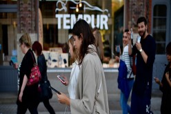 Young players walk through the city centre of Hanover while holding their smartphones and playing 'Pokemon Go' on July 15, 2016 in Hanover, Germany. 1.200 players have participated in the night walk through the city centre until midnight. 'Pokemon Go' is 