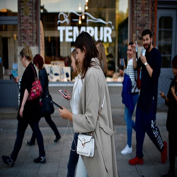 Young players walk through the city centre of Hanover while holding their smartphones and playing 'Pokemon Go' on July 15, 2016 in Hanover, Germany. 1.200 players have participated in the night walk through the city centre until midnight. 'Pokemon Go' is 