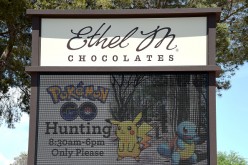 An electronic sign displays a message setting hours for Pokemon Go players at Ethel M Chocolates on August 2, 2016 in Henderson, Nevada. 