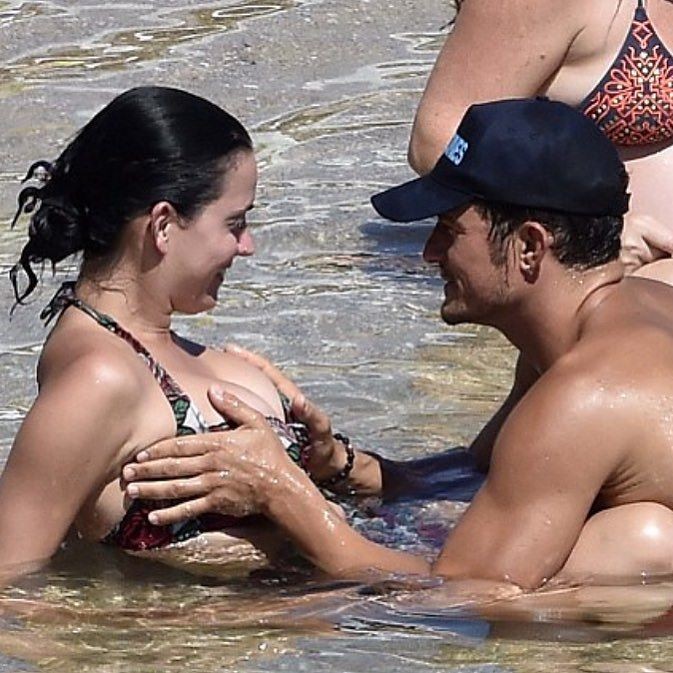 Orlando Bloom and Katy Perry's romantic moments at Sardinia also include Bloom grabbing Perry's breast and the two kissing. 