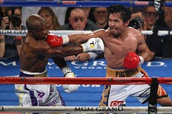 Manny Pacquiao (R) throws a right at Timothy Bradley Jr. in the seventh round of their welterweight fight at MGM Grand Garden Arena on April 9, 2016 in Las Vegas, Nevada.