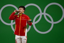 Long Qingquan of China wins the men's 56kg category of the Rio 2016 Olympic Games weightlifting events at the Riocentro in Rio de Janeiro, Brazil, Aug. 7, 2016. 