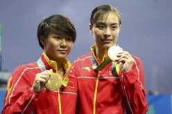 Chinese diving athletes Wu Minxia and Shi Tingmao show gold medals at the awarding ceremony of women's SYNC.3M Springboard in Rio on Sunday.