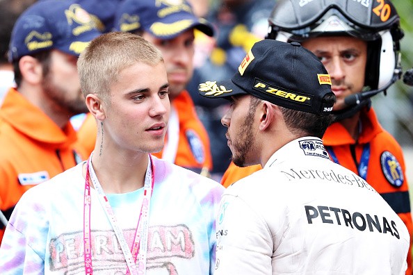 Lewis Hamilton of Great Britain and Mercedes GP talks to singer Justin Bieber at the podium during the Monaco Formula One Grand Prix at Circuit de Monaco on May 29, 2016 in Monte-Carlo, Monaco.  