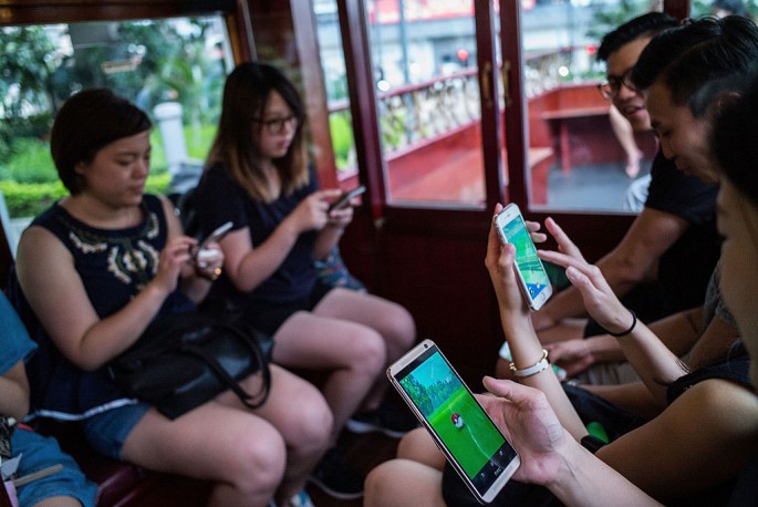  People are seen playing during Hong Kong's first 'Pokemon Go' tram party organized by 'Sam the Local', on July 30, 2016 in Hong Kong.