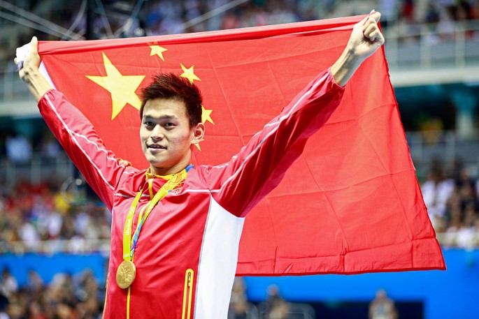 Gold medalist Yang Sun of China brandishes correct Chinese flag during the medal ceremony of Day 3 of the Rio 2016 Olympic Games.