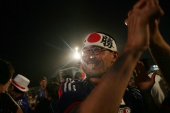 Japan supporters celebrate after their first goal against Colombia while watching at the FIFA Fan Fest on Copacabana Beach on June 24, 2014 in Rio de Janeiro, Brazil.